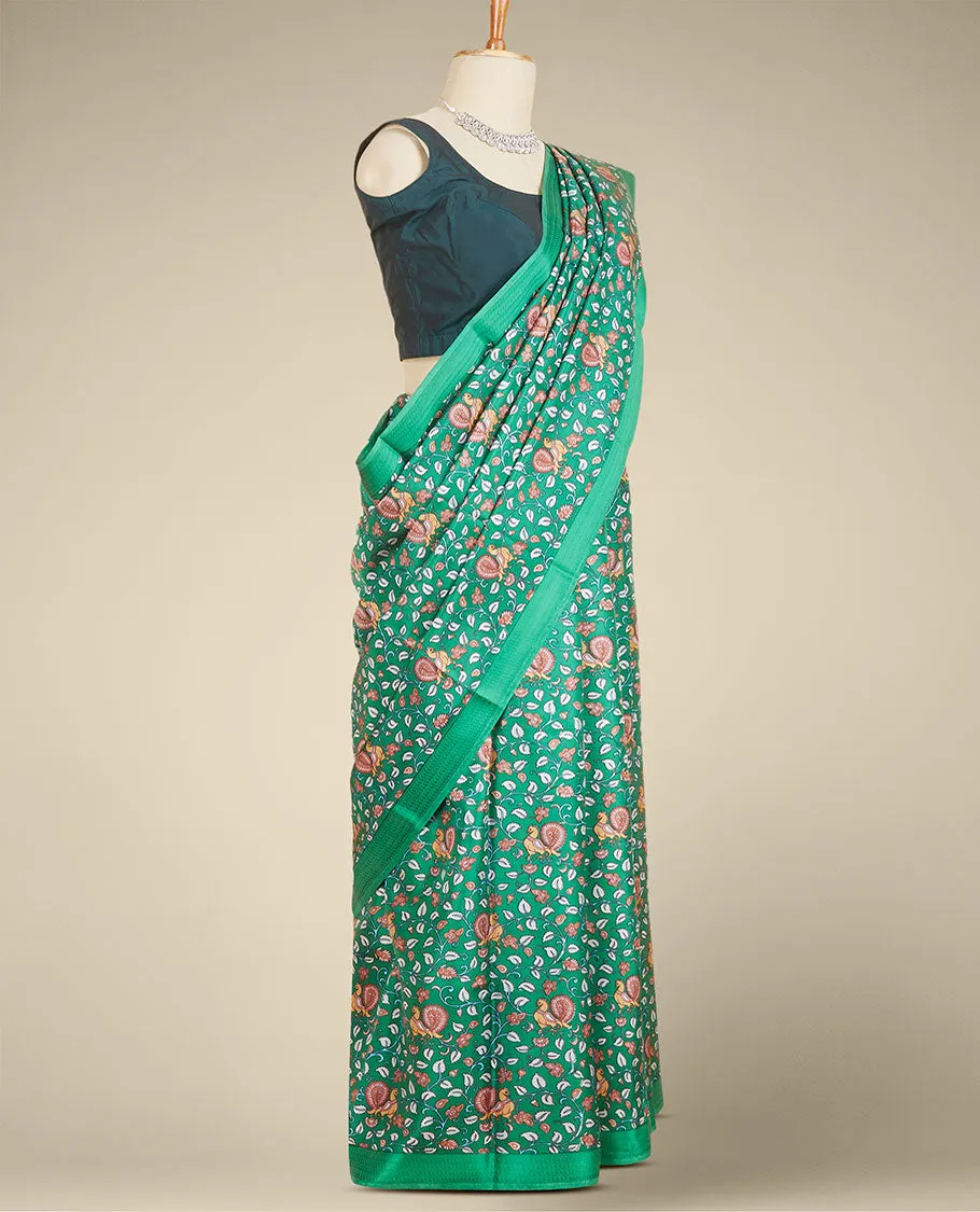 Green kalamkari-style floral vine & peacock printed silk saree, paisley motifs border